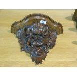 A carved scrolling wall bracket
