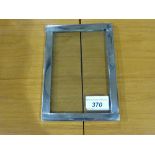A white metal photo frame with unusual h