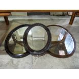 Three various oval framed mirrors