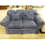 A blue two seater sofa
