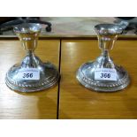 A pair of white metal candlesticks marke