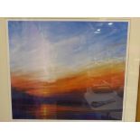 A large framed print of a sunset