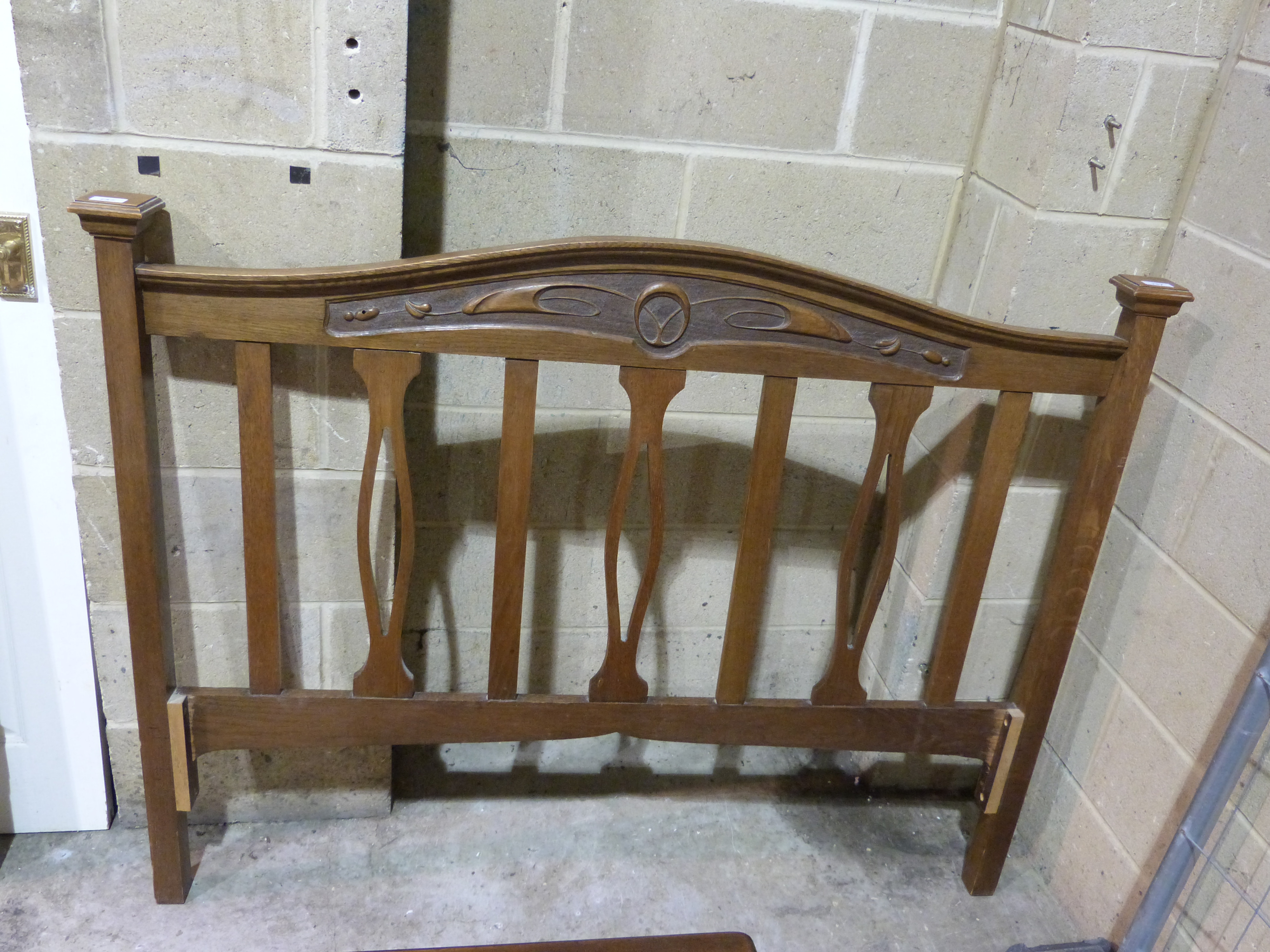 A carved oak Art Nouveau bed head