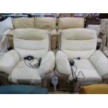 A pair of electric recliner armchairs