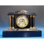 A slate mantel clock with Romanesque pil