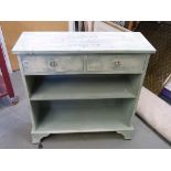 A painted bookshelf with two drawers abo