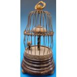 A novelty bird cage clock with moving bi
