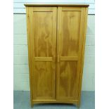 A small two door pine wardrobe (W95.5cm