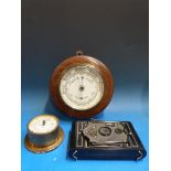 An aneroid barometer, a smaller marine e