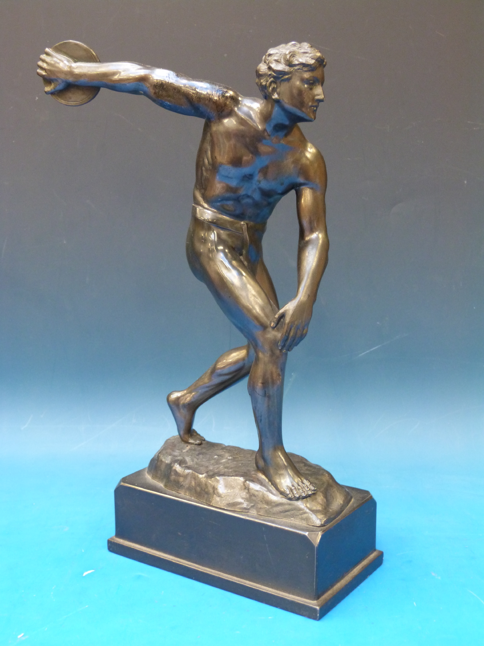 A spelter figure of a discus thrower on