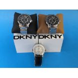 Three DKNY wristwatches, one on leather