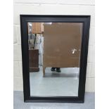 A black framed mirror with bevelled glas