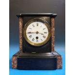 A small black slate mantel timepiece wit