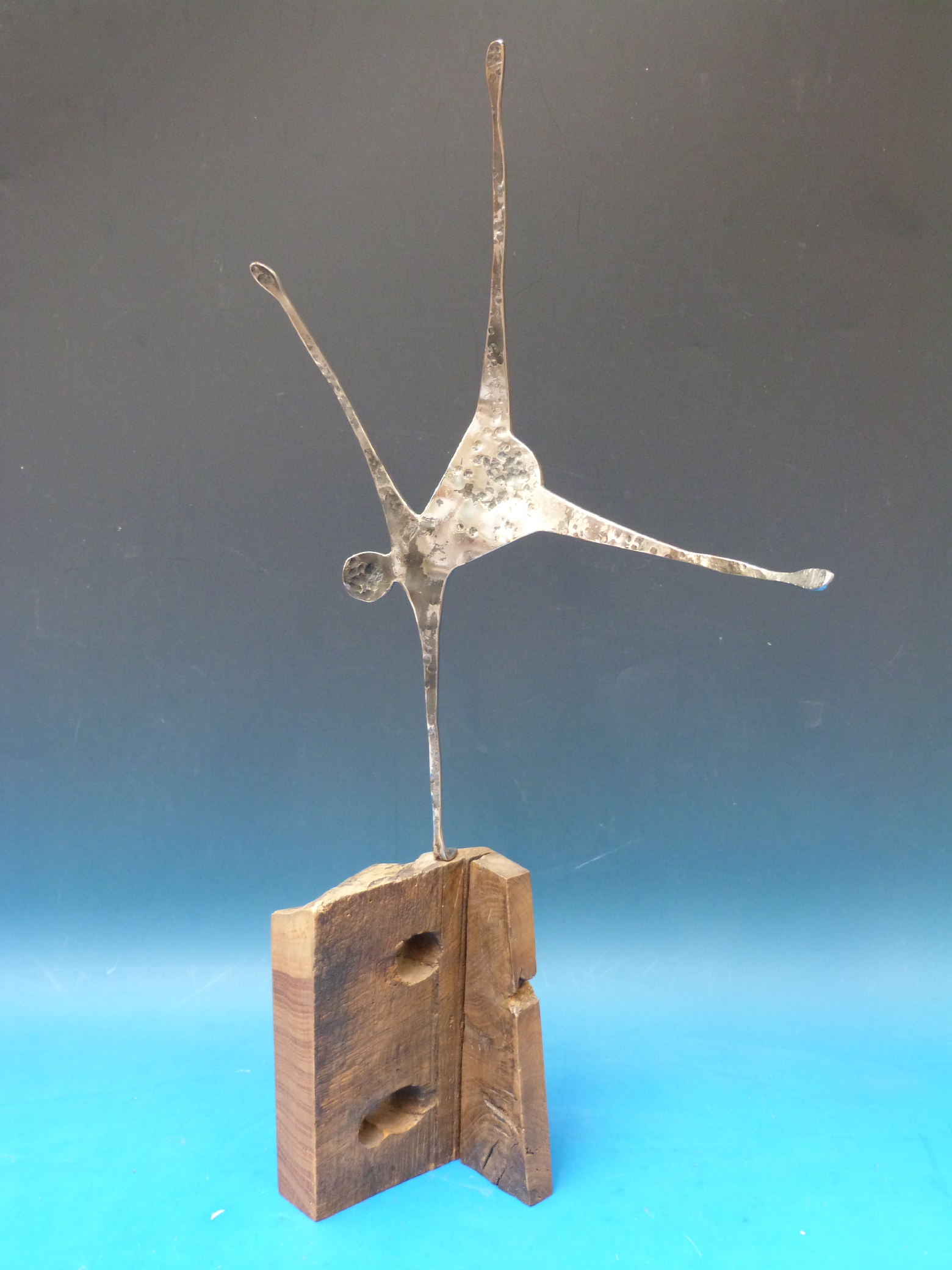 A hammered steel and wood sculpture of