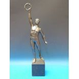 A spelter figure of an athlete holding a