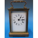 A brass cased carriage clock with enamel