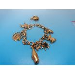 A 9ct gold charm bracelet with eight yel