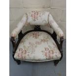 A 19thC upholstered tub chair raised on