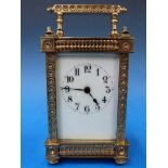 A French carriage clock in ornate gilt c