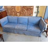 A blue three seat sofa retailed by Harro