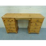 A pine twin pedestal desk (W133 x D38 x