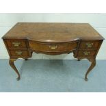 A burr walnut dressing table raised on c