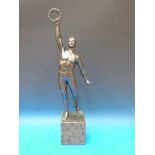 A spelter figure of an athlete holding a