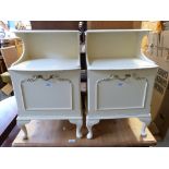 A pair of white painted bedside cabinets