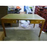 A light oak desk fitted two drawers (wid