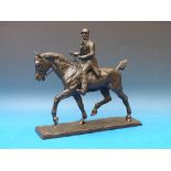 A cast bronze of a horse and rider