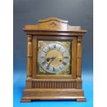 An oak cased bracket mantel clock with t