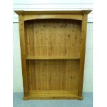 A large pine bookcase with facility for