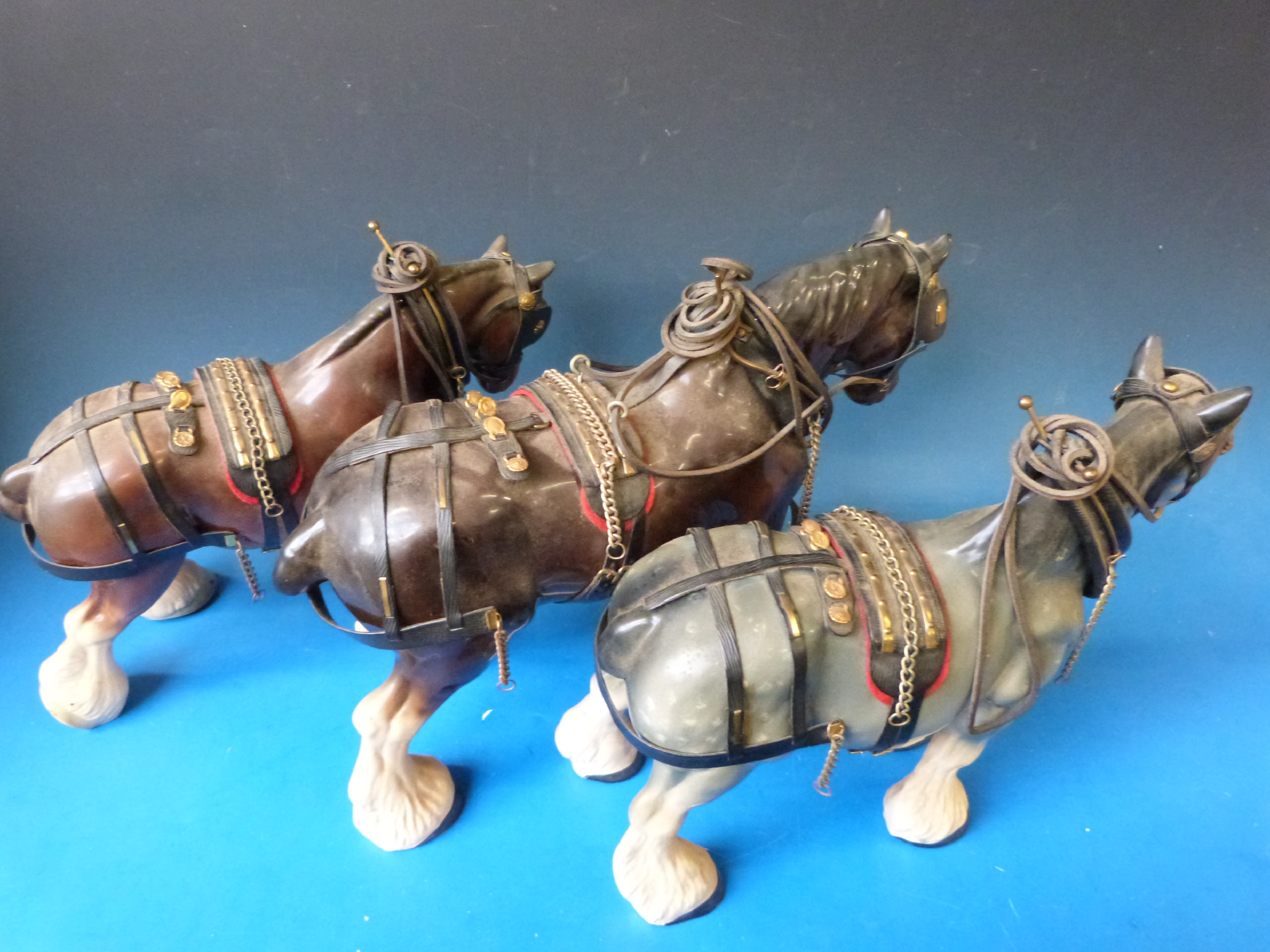 Four harnessed ceramic Shire horses and wooden cart