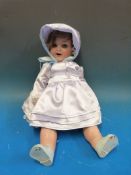 A Heubach Koppelsdorf doll with open mouth, weighted blue eyes, brown hair and jointed limbs,