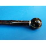 A walking cane with spherical tigers eye knop