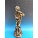 A large bronzed spelter figure of a boy fishing,