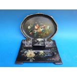 A lacquer desk stand with hand-painted floral and butterfly decoration and two glass ink wells,