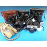 Three pairs of cased binoculars and various camera equipment