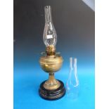 A Duplex brass oil lamp on painted ceramic base