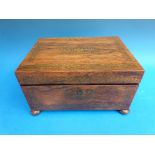 A brass inlaid rosewood work box raised on bun feet and with fitted interior,