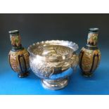 A large embossed silver plated bowl together with a pair of continental ceramic vases