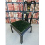 A Chinese ebonised chair with gilt decoration of a pagoda to the shaped splat and drop in