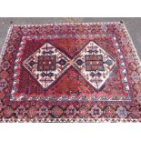 A Turkoman rug with two diagonal guls (204 x 153cm)