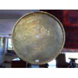 A large intricately inscribed brass tray, 75cm in diameter,