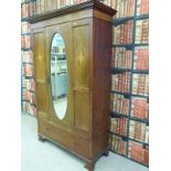 An Edwardian style wardrobe with inlaid decoration and single drawer to base and glass mirror to