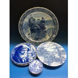 A blue and white Delft charger (40cm diameter) with decoration of a couple on a horse-drawn sleigh,