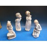 Four various Nao figures of children including one of a girl with a doll and another holding a