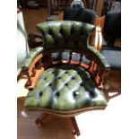 A button back green leather captain's chair