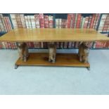 A hardwood coffee table with figural elephant supports (length 122cm) and figural elephant wine