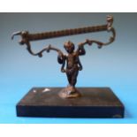 A set of 18thC bronze scales, formed as a cherub supporting scrolling mounts,